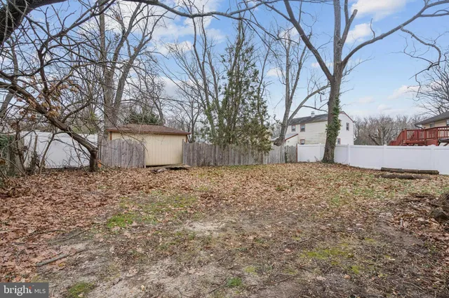 a view of a yard with a house and trees