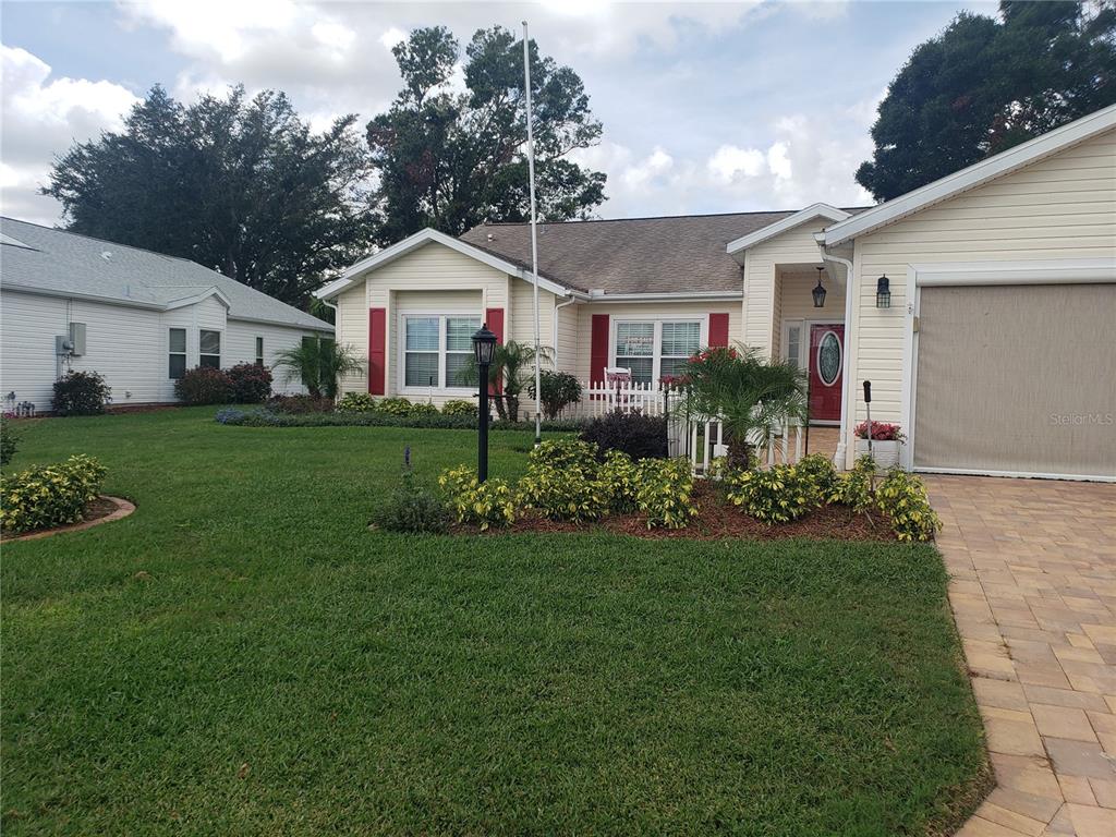 25121 Meriweather Road Leesburg, FL 34748 - Photo 1 of 1 a front view of a house with a yard and trees
