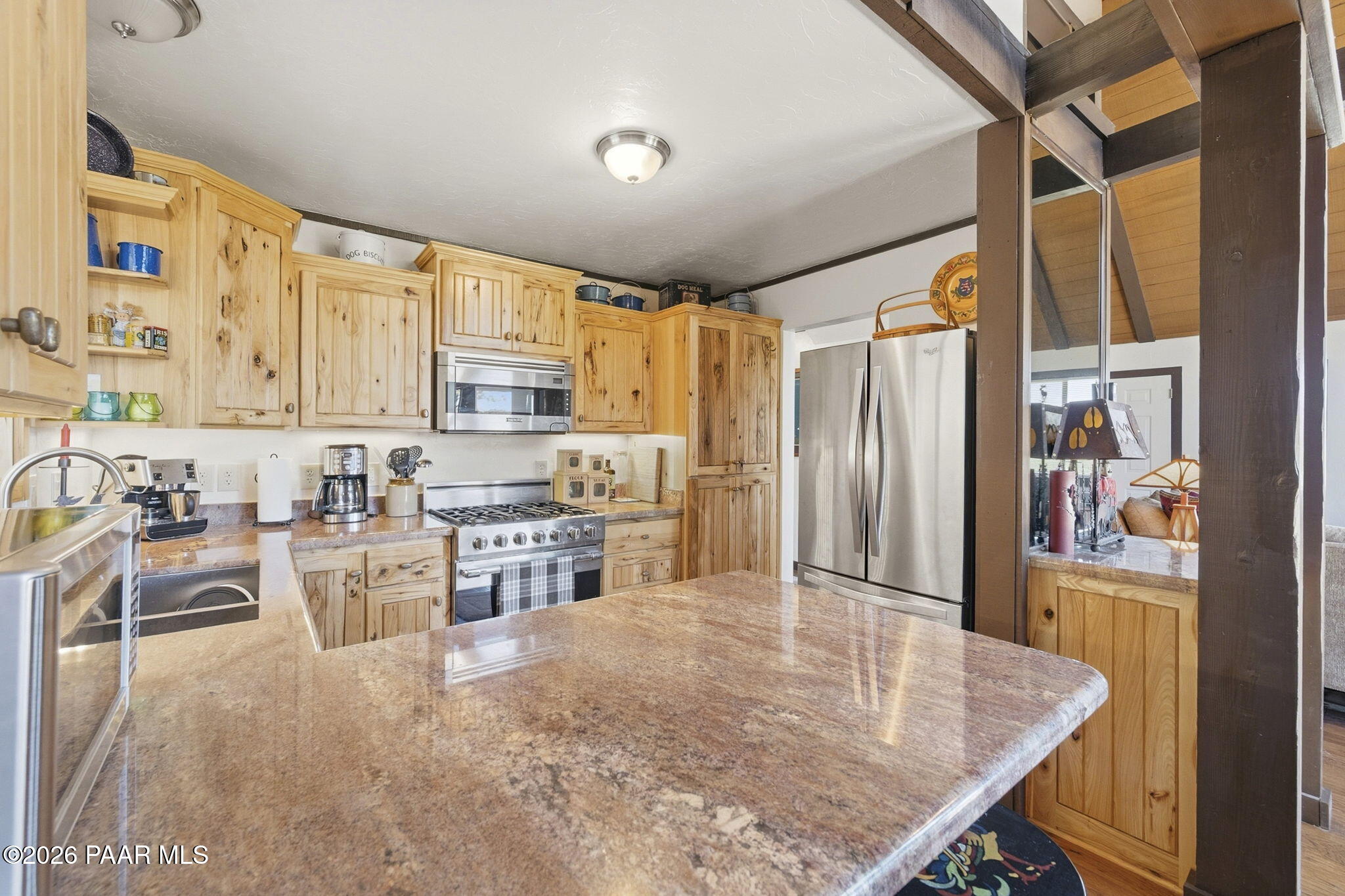 7251 South Big Bug Mesa Road Mayer, AZ 86333 - Photo 19 of 55 a kitchen with stainless steel appliances granite countertop a refrigerator a stove and a sink with couches