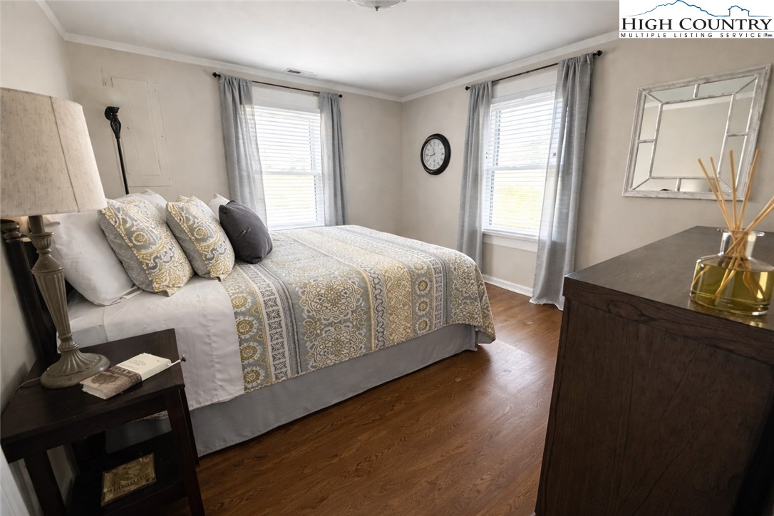 230 Beaver Creek Road West Jefferson, NC 28694 - Photo 13 of 20 a bedroom with a bed and wooden floor
