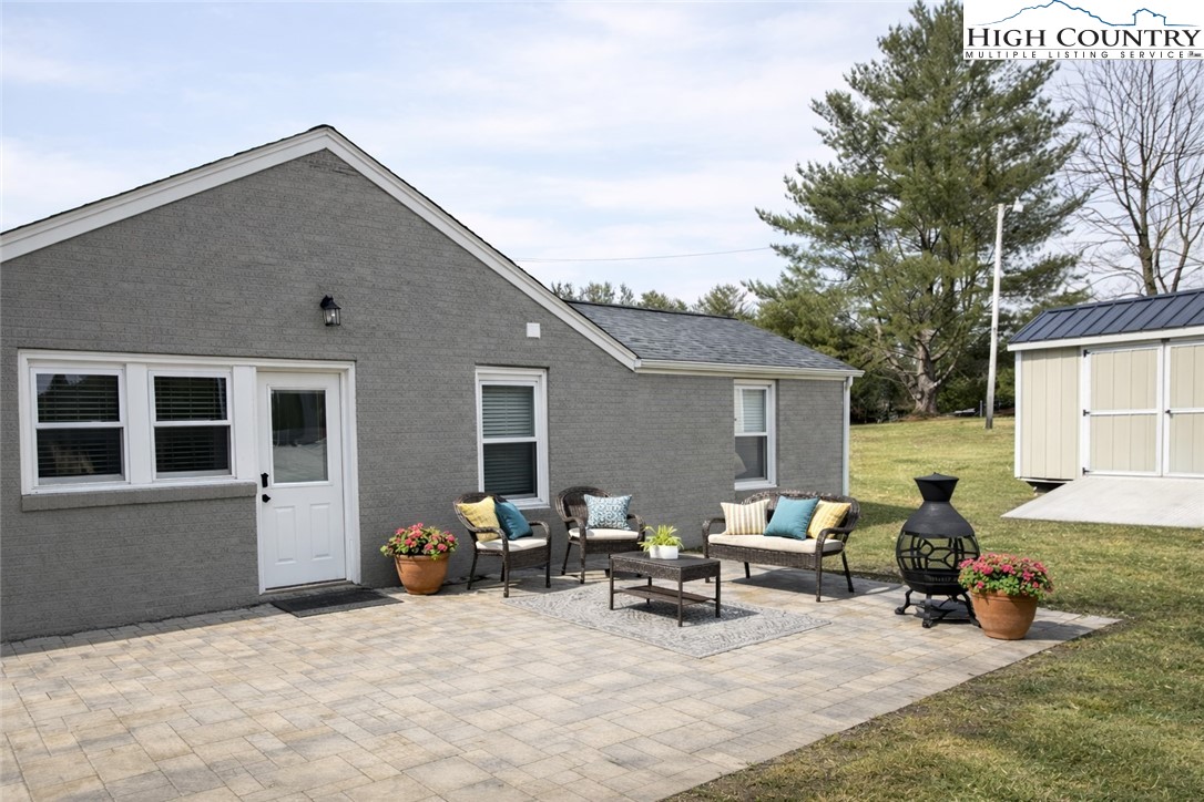 230 Beaver Creek Road West Jefferson, NC 28694 - Photo 19 of 20 a view of a backyard with a patio and a fire pit