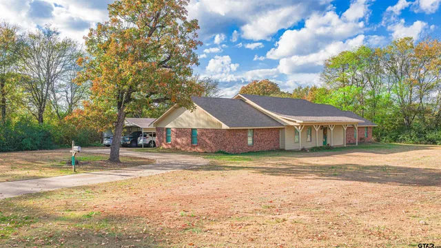 a house that has a tree in front of it