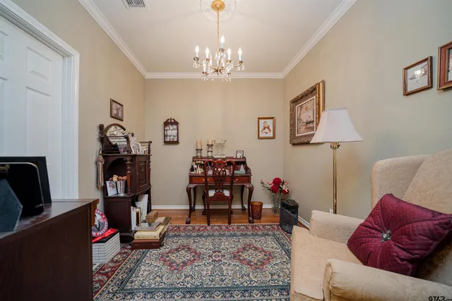 a living room with furniture and a chandelier