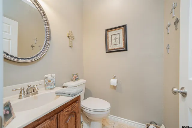 a bathroom with a toilet a sink and mirror