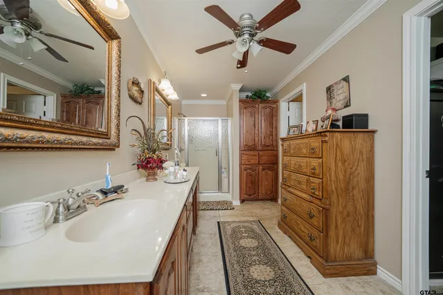 a bathroom with double vanity sink and a mirror
