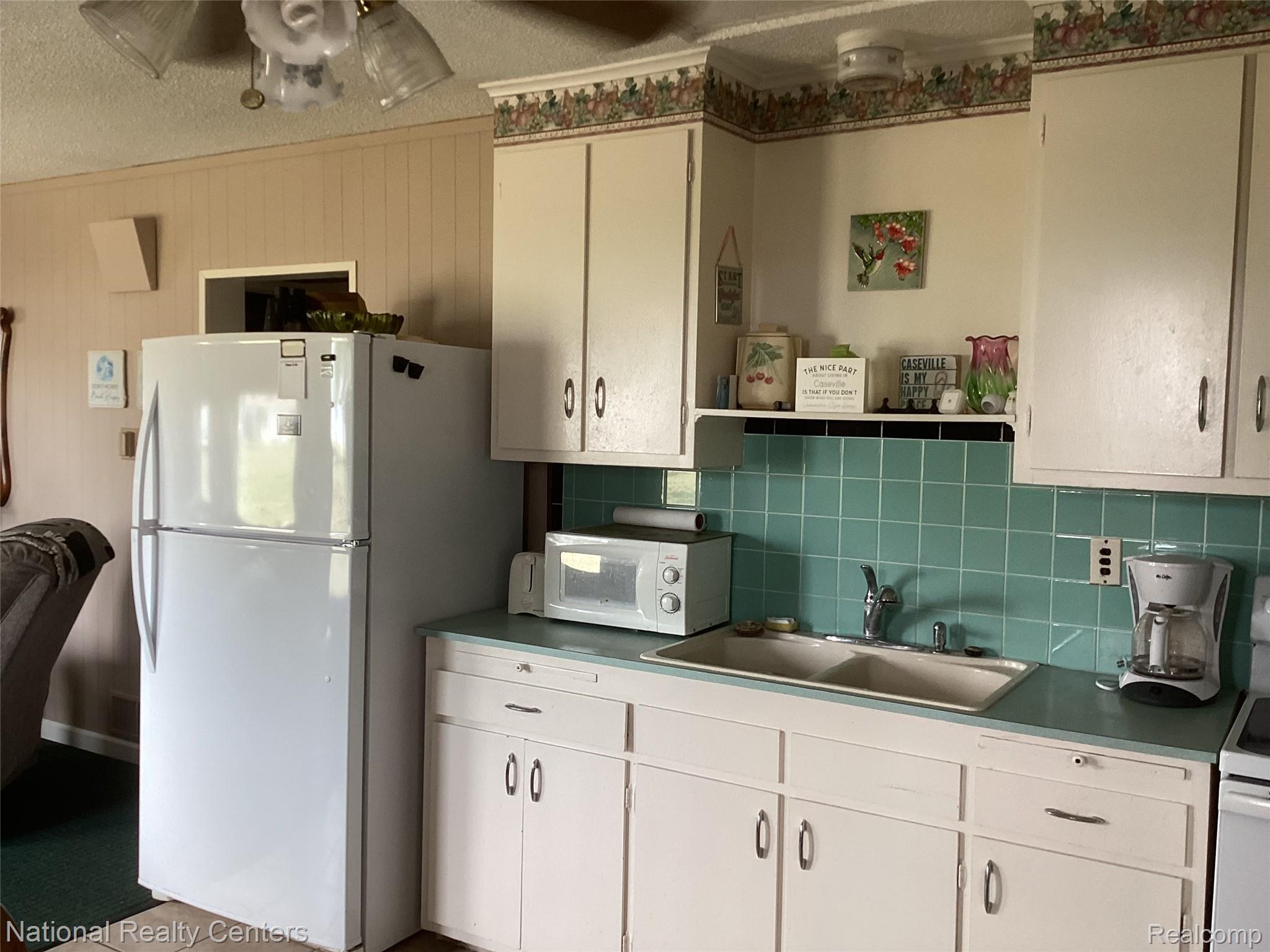 6024 Port Austin Road, Unit 5 Caseville, MI 48725 - Photo 11 of 56 Fridge, micro dishes, glasses, pots pans stay