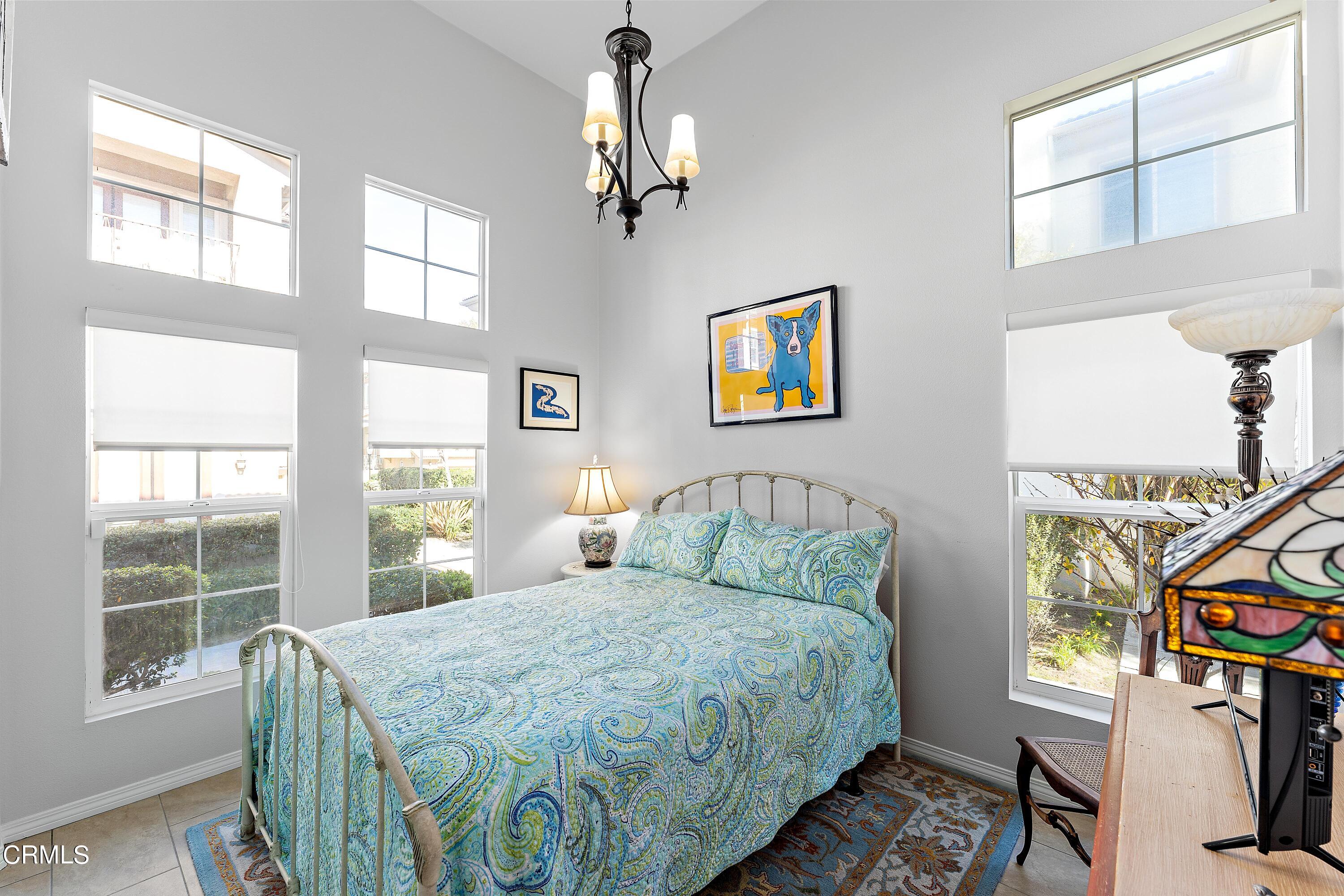 1239 Bayside Lane Oxnard, CA 93035 - Photo 12 of 27 a bedroom with a bed a dresser next to a window