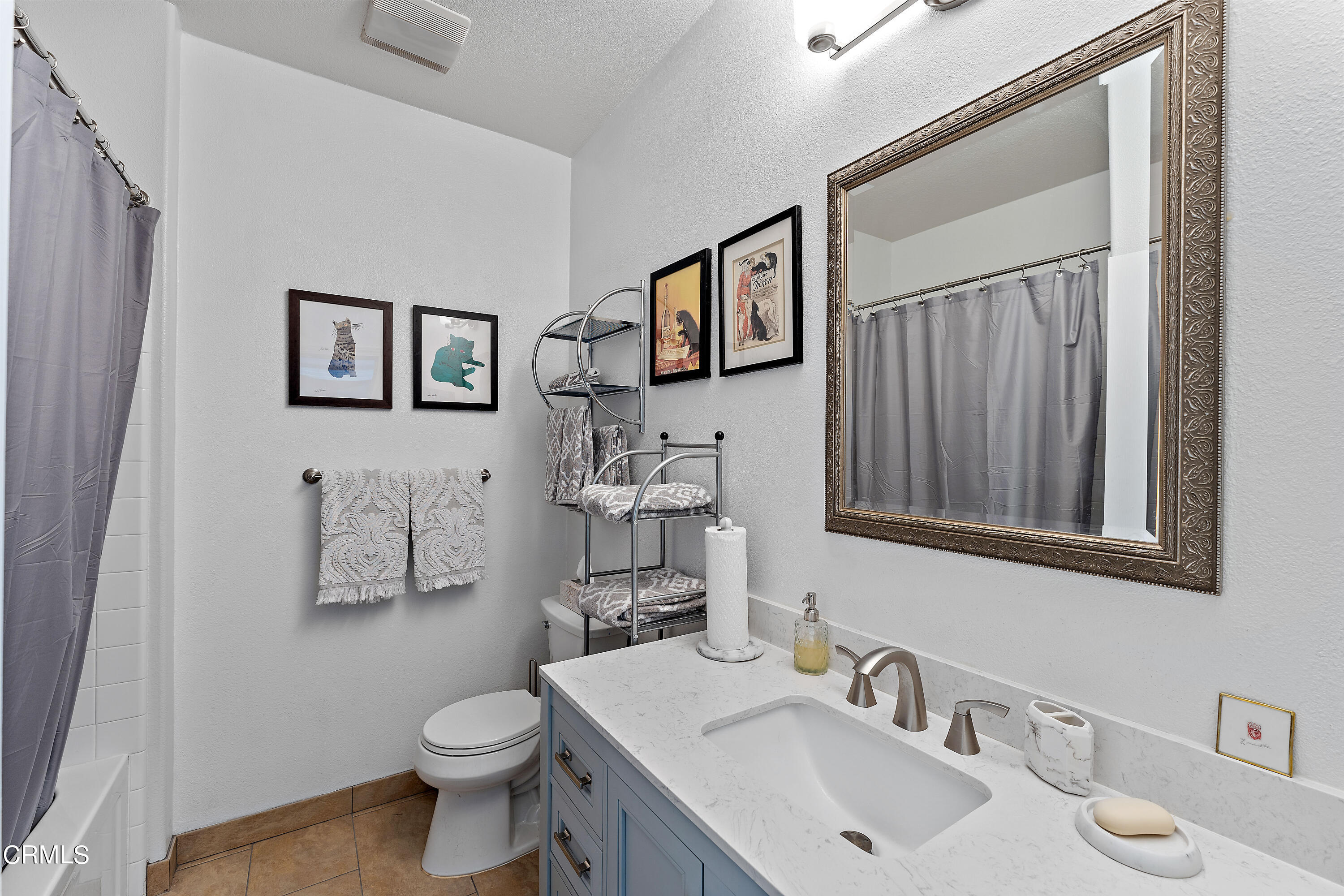 1239 Bayside Lane Oxnard, CA 93035 - Photo 17 of 27 a bathroom with a toilet sink and mirror