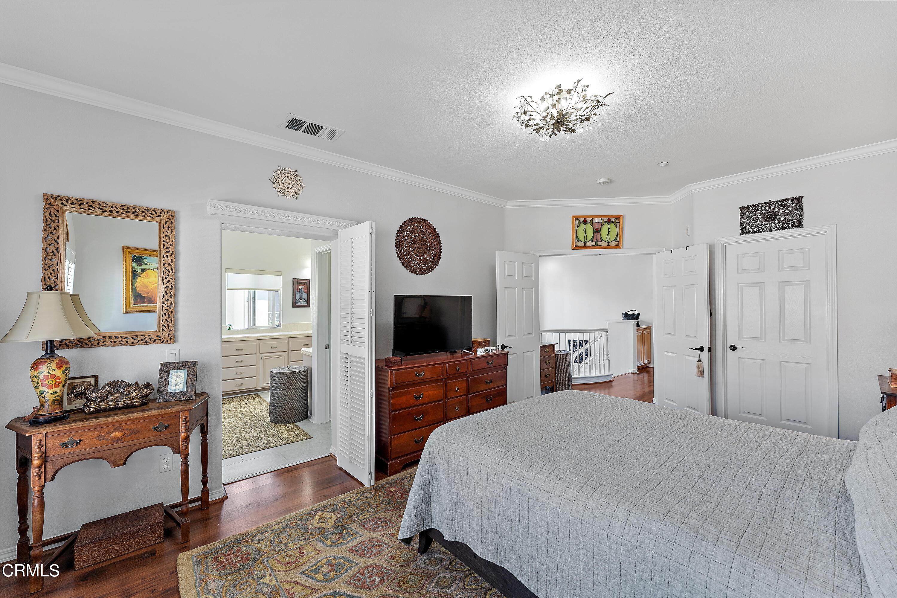 1239 Bayside Lane Oxnard, CA 93035 - Photo 19 of 27 a bedroom with a bed and a flat screen tv