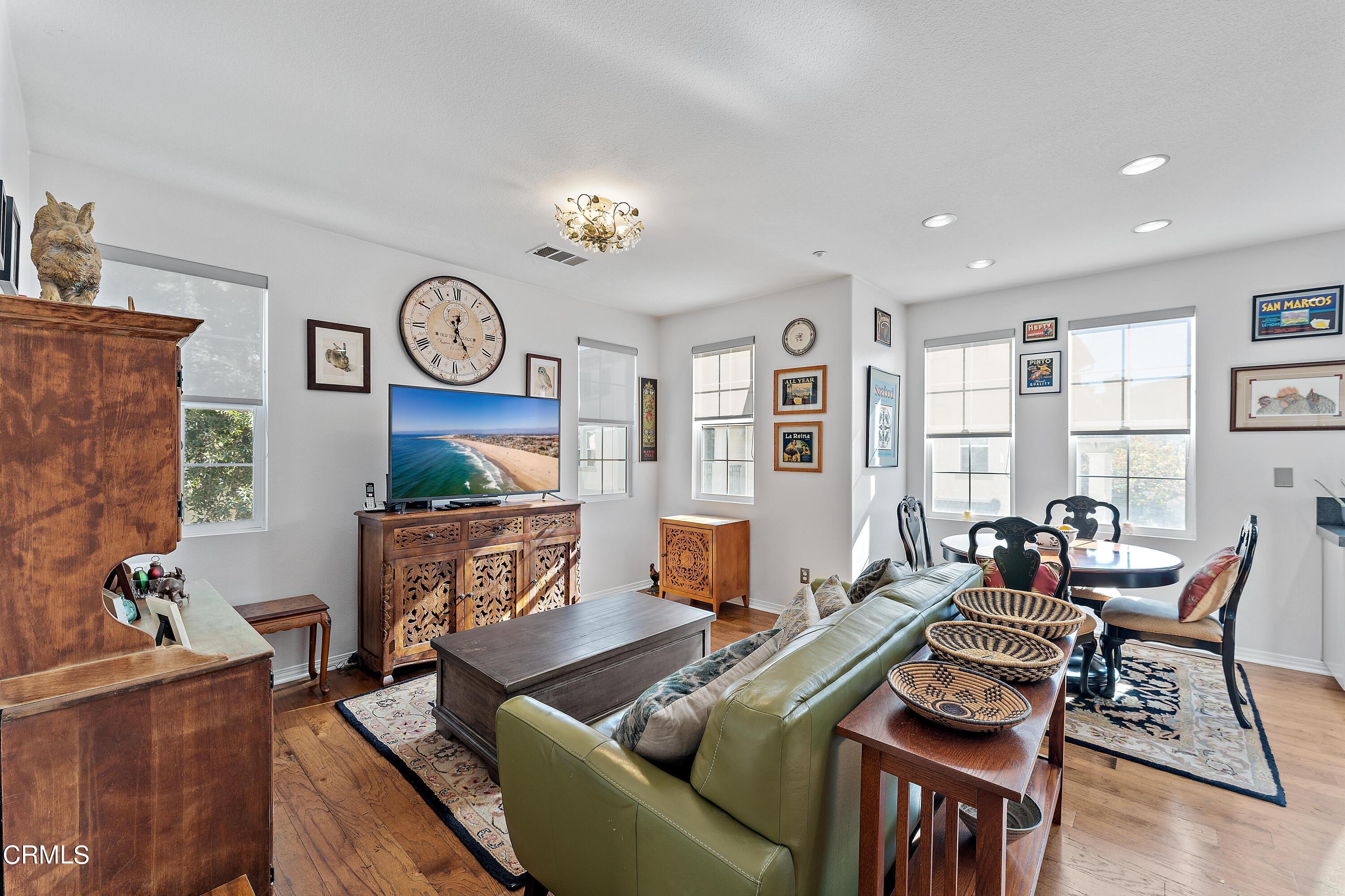 1239 Bayside Lane Oxnard, CA 93035 - Photo 7 of 27 a living room with furniture a rug and a clock