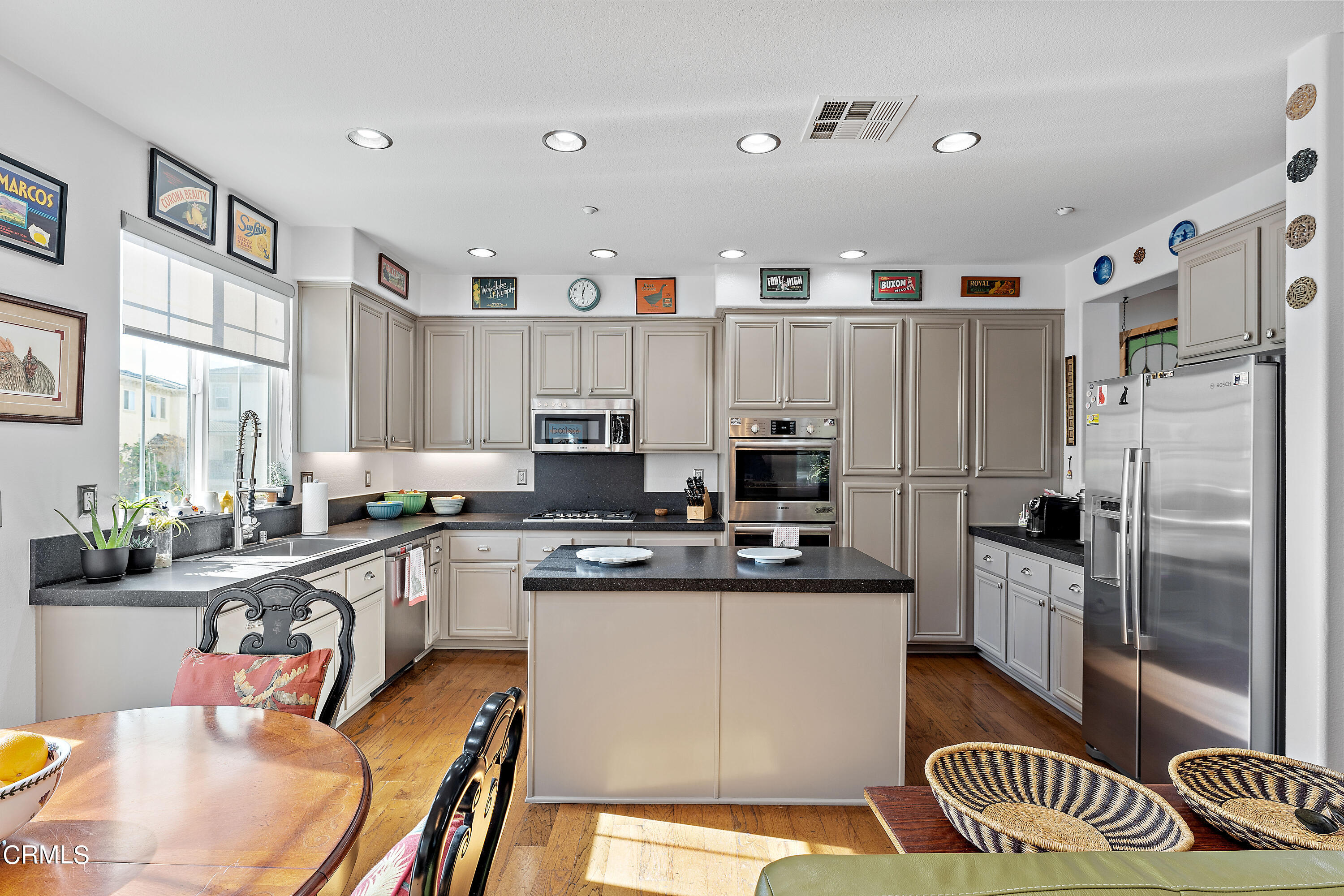 1239 Bayside Lane Oxnard, CA 93035 - Photo 9 of 27 a kitchen with stainless steel appliances a stove a sink and a refrigerator