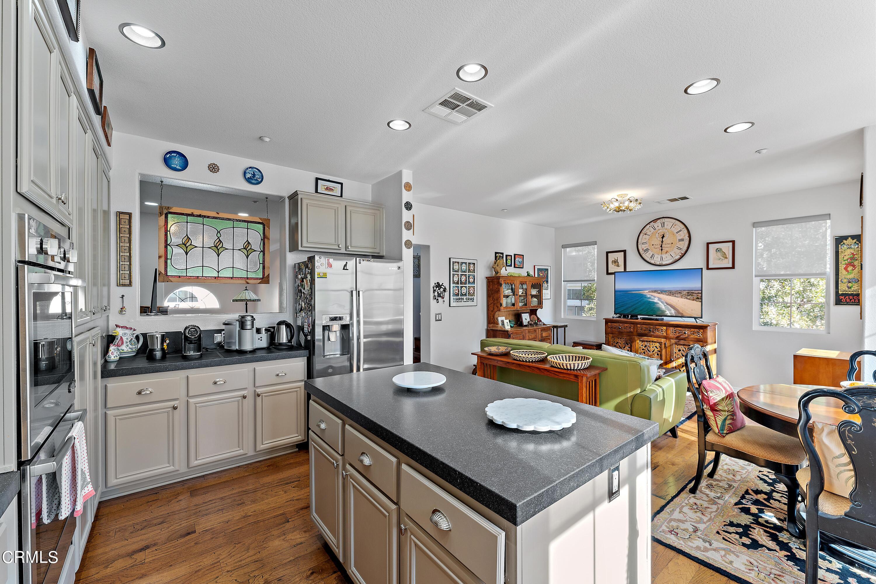1239 Bayside Lane Oxnard, CA 93035 - Photo 10 of 27 a open kitchen with stainless steel appliances granite countertop a stove and a refrigerator