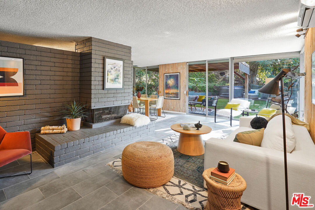 1430 Benedict Canyon Drive Beverly Hills, CA 90210 - Photo 2 of 2 a living room with furniture and a large window