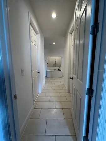 a view of a bathroom with a tub shower and mirror