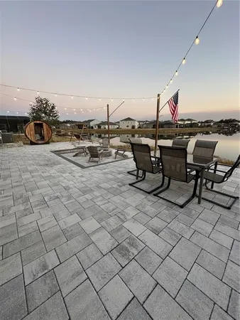 a view of a patio with table and chairs with wooden floor and fence