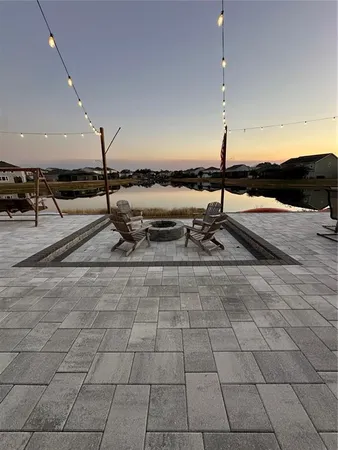 a swimming pool with outdoor seating and yard