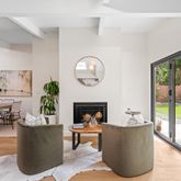 a living room with fireplace furniture and a large window