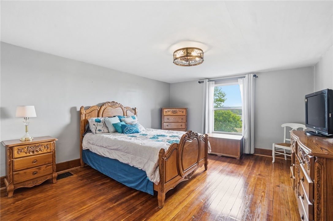 6155 North Union Road Clayton, OH 45315 - Photo 37 of 59 This spacious bedroom features warm hardwood floors and a bright window.
