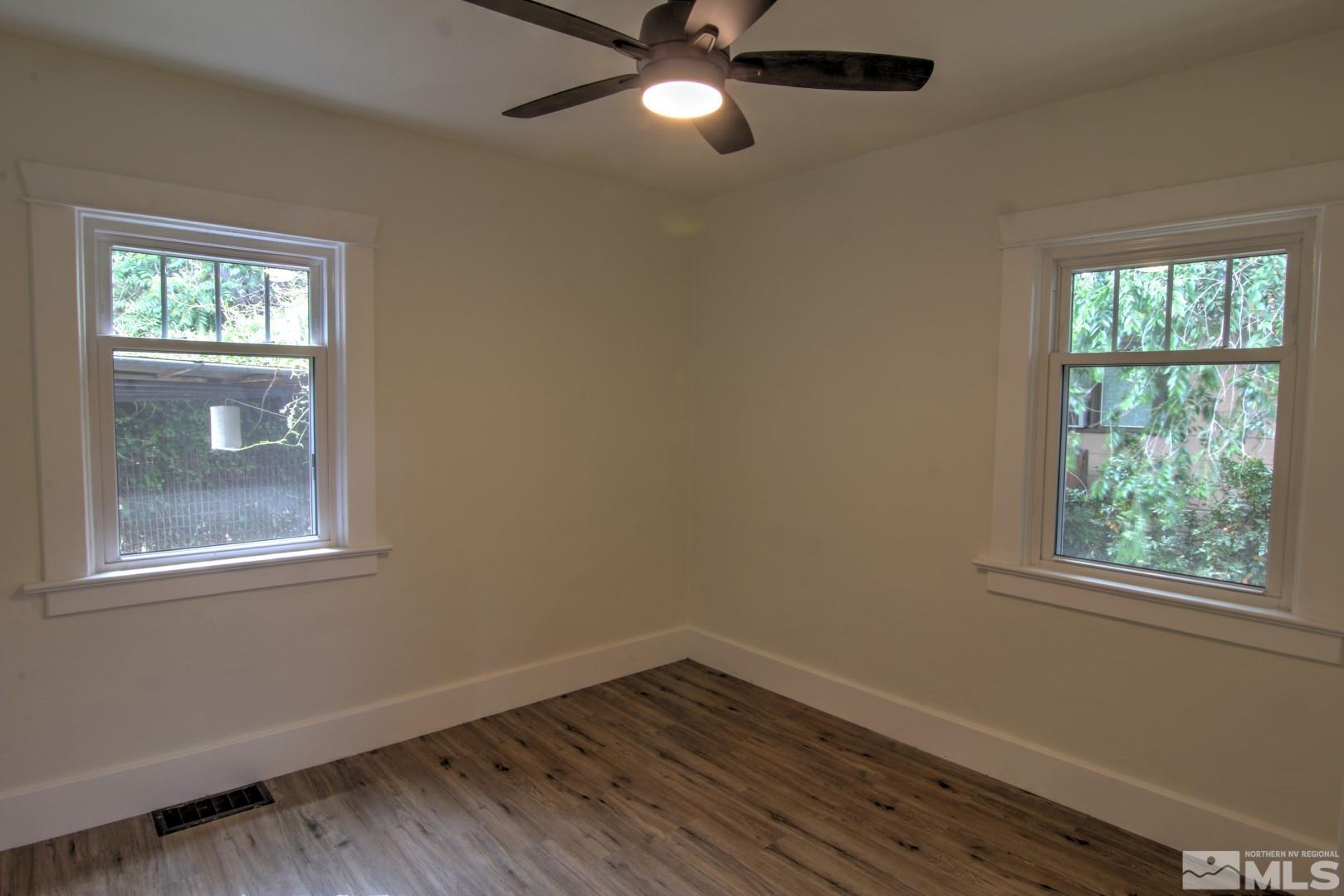 440 East 8th Street Reno, NV 89512 - Photo 11 of 23 a view of an empty room with wooden floor and a window