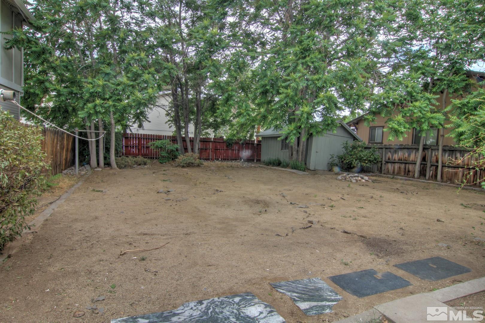 440 East 8th Street Reno, NV 89512 - Photo 17 of 23 a view of a backyard with large trees and a barn