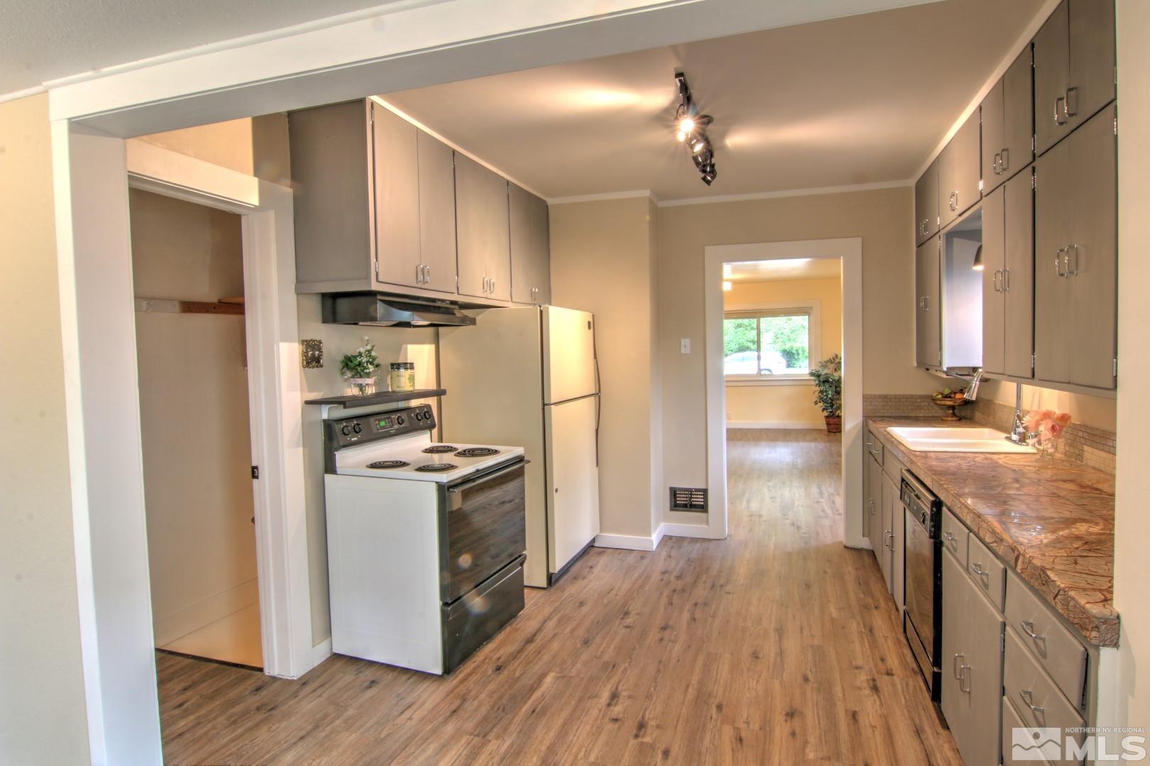 440 East 8th Street Reno, NV 89512 - Photo 5 of 23 a kitchen with kitchen island wooden floors appliances and cabinets