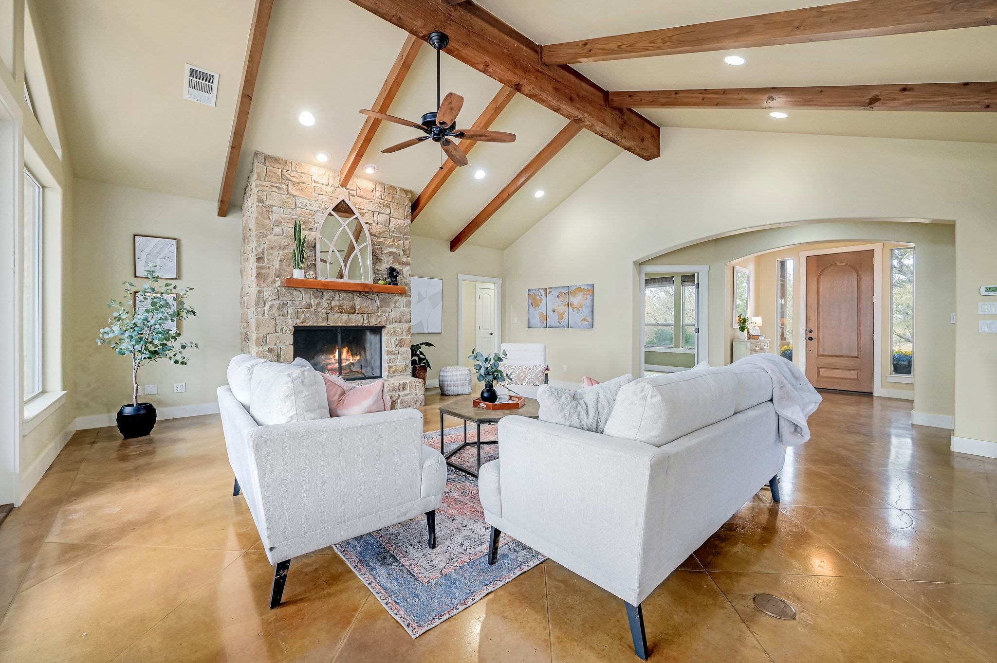 2551 Wolf Creek Ranch Road Burnet, TX 78611 - Photo 5 of 40 Living area featuring arched walkways, recessed lighting, a fireplace, and a ceiling fan