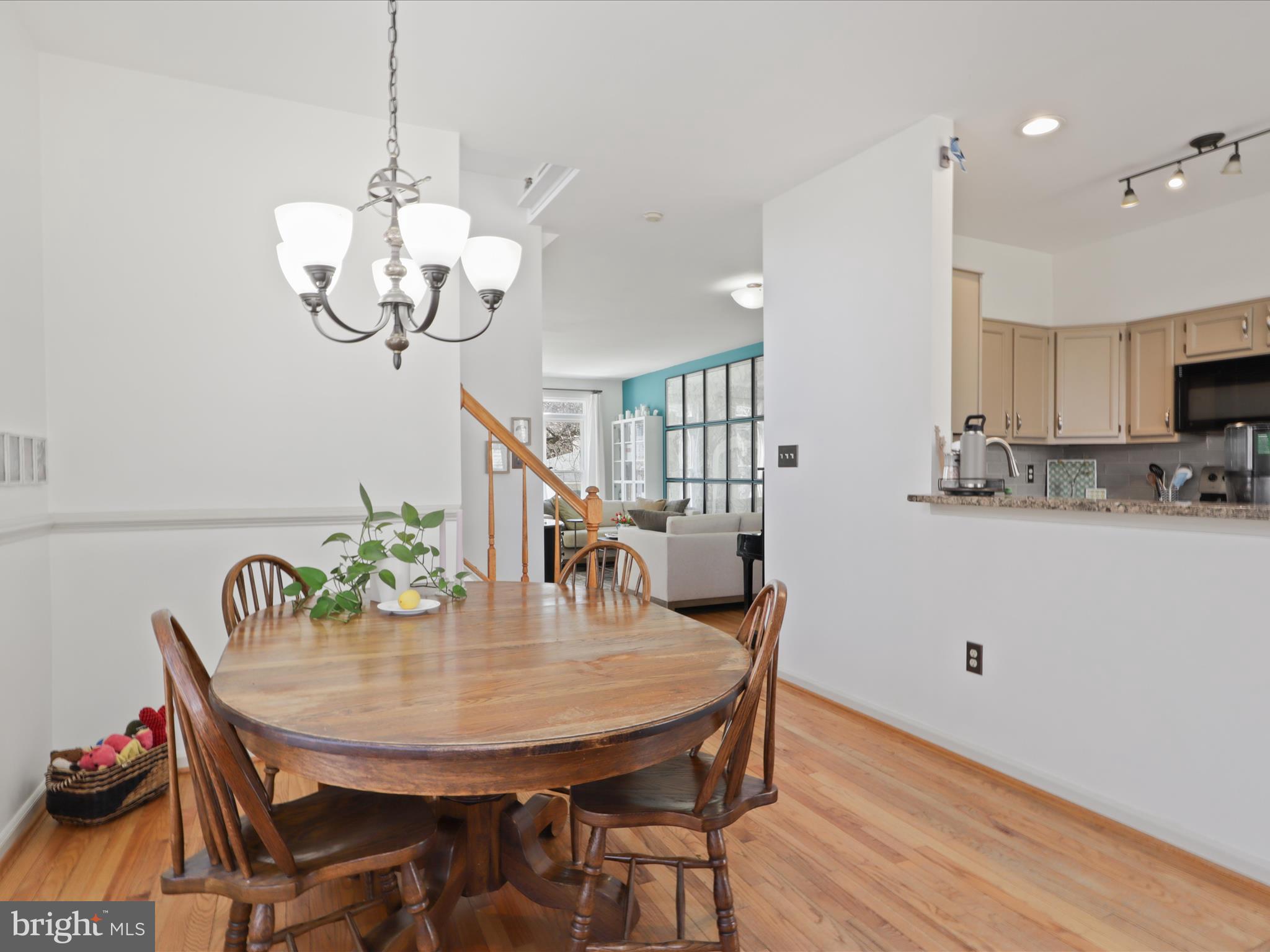 3906 Elbert Avenue Alexandria, VA 22305 - Photo 10 of 40 a view of a dining room with furniture a chandelier and wooden floor