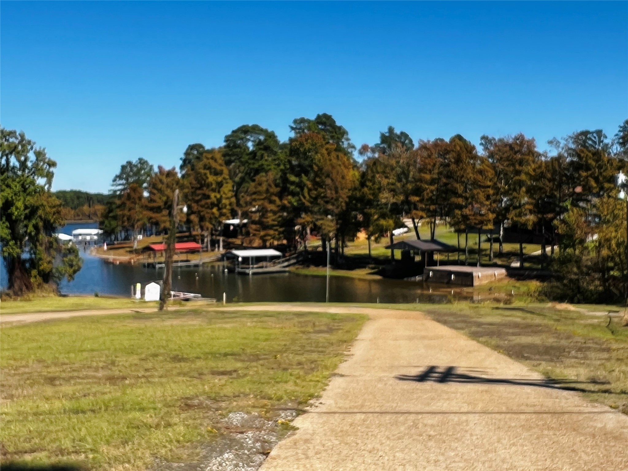 523 Beechridge Loop Hemphill, TX 75948 - Photo 18 of 18 a swimming pool that has lawn chairs and a dining table under an umbrella