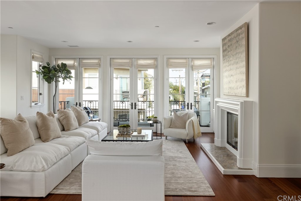 2211 Vista Drive Manhattan Beach, CA 90266 - Photo 21 of 48 a living room with furniture large windows and wooden floor