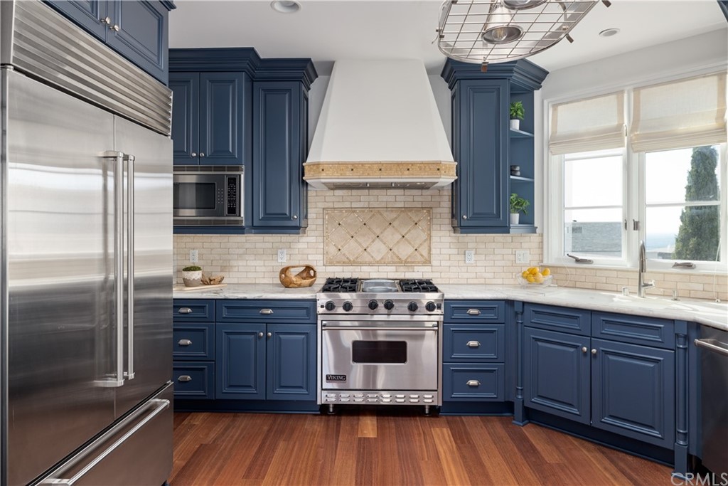 2211 Vista Drive Manhattan Beach, CA 90266 - Photo 27 of 48 a kitchen with stainless steel appliances granite countertop a stove a refrigerator and a wooden cabinets