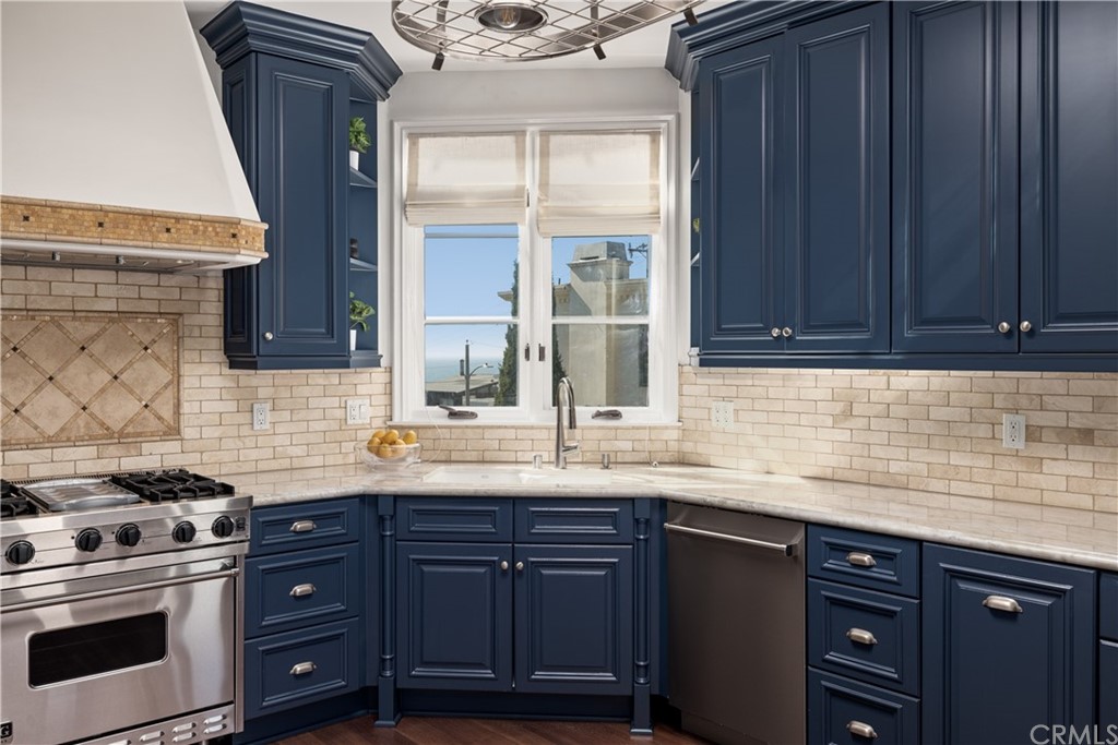 2211 Vista Drive Manhattan Beach, CA 90266 - Photo 28 of 48 a kitchen with granite countertop stainless steel appliances a sink window and cabinets