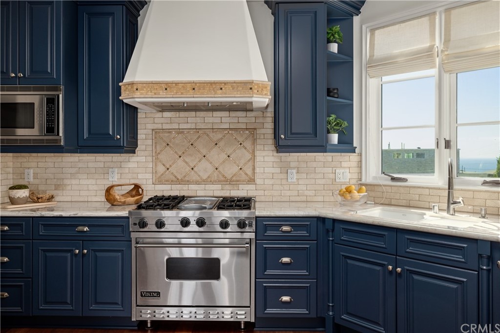 2211 Vista Drive Manhattan Beach, CA 90266 - Photo 29 of 48 a kitchen with stainless steel appliances a stove a sink and a microwave