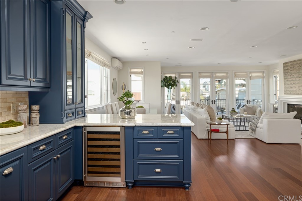 2211 Vista Drive Manhattan Beach, CA 90266 - Photo 31 of 48 a kitchen with granite countertop a stove a sink and a living room with wooden floor
