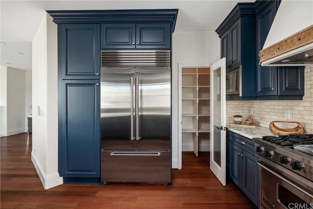 2211 Vista Drive Manhattan Beach, CA 90266 - Photo 33 of 48 a kitchen with stainless steel appliances cabinets and a wooden floor
