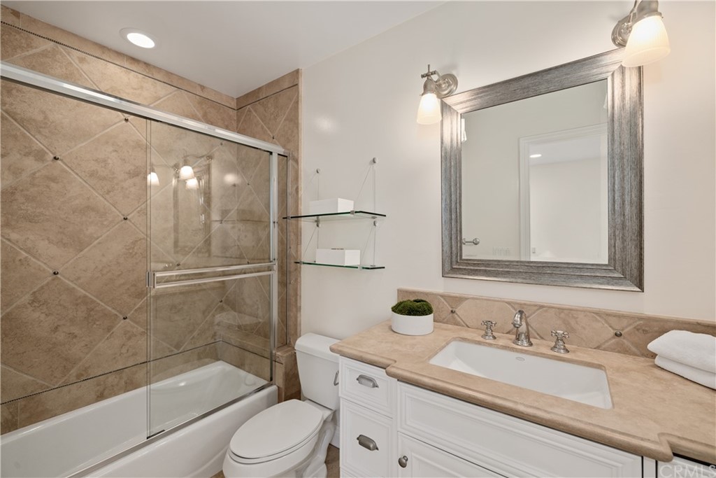 2211 Vista Drive Manhattan Beach, CA 90266 - Photo 42 of 48 a bathroom with a granite countertop sink toilet and shower