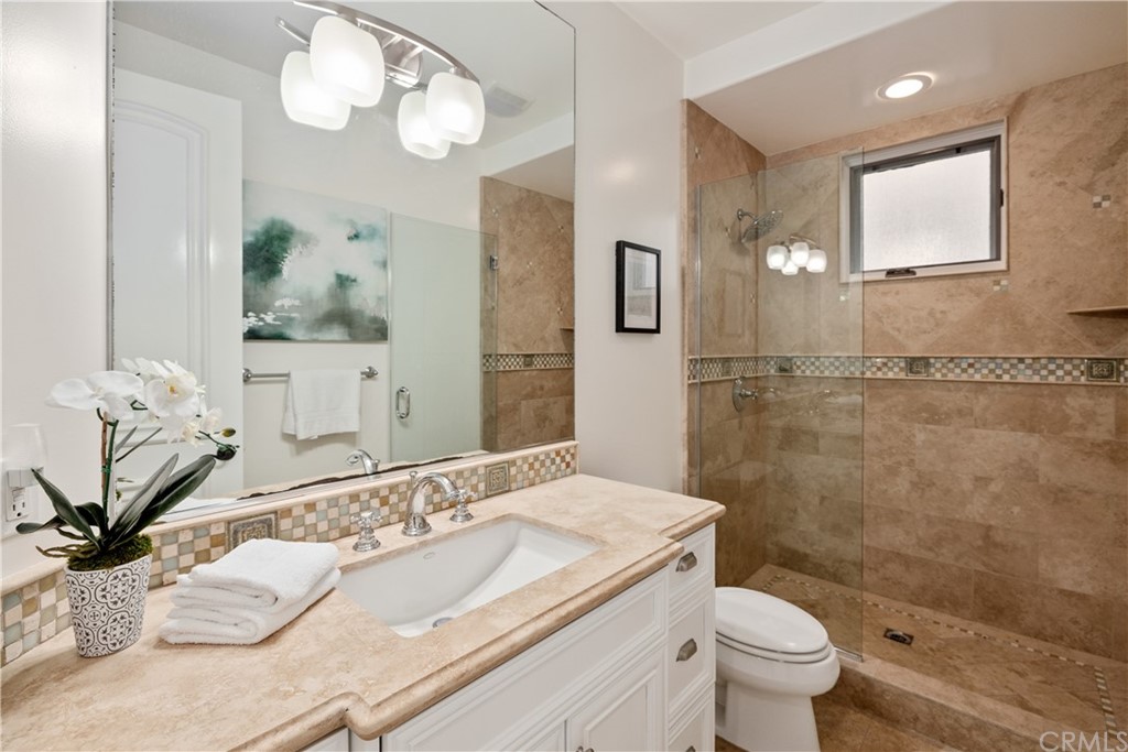 2211 Vista Drive Manhattan Beach, CA 90266 - Photo 45 of 48 a bathroom with a granite countertop sink a toilet and a mirror