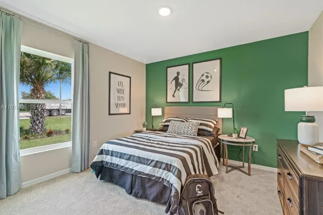 a bedroom with a bed and a painting on the wall