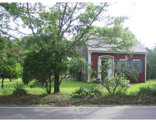 114 Upper County Road Dennis, MA 02660 - Photo 2 of 5 front view of a house with a garden
