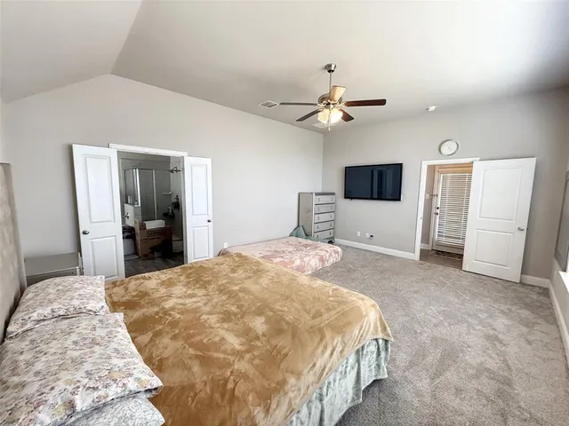 a bedroom with a bed and cabinet
