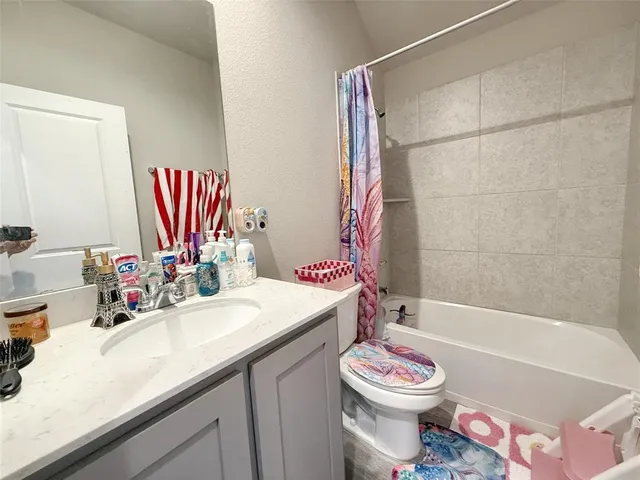 a bathroom with a sink a toilet and a bathtub