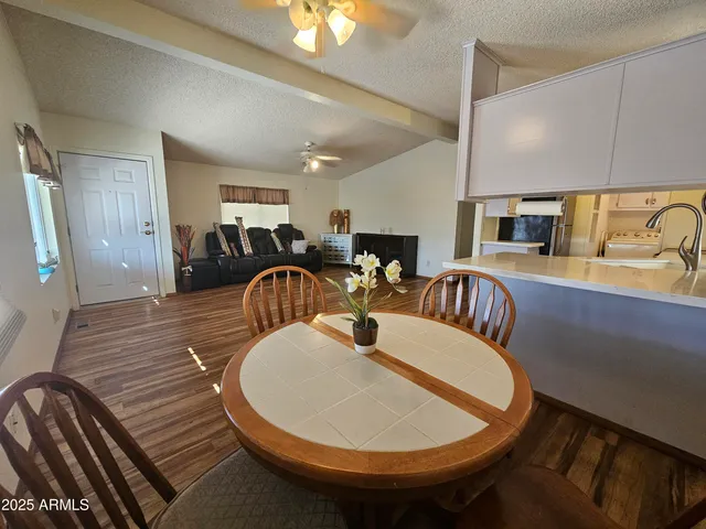 a dining room with furniture and wooden floor