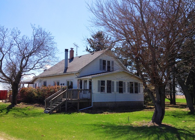 8720 Elva Road DeKalb, IL 60115 - Photo 1 of 25 a front view of a house with a garden and trees