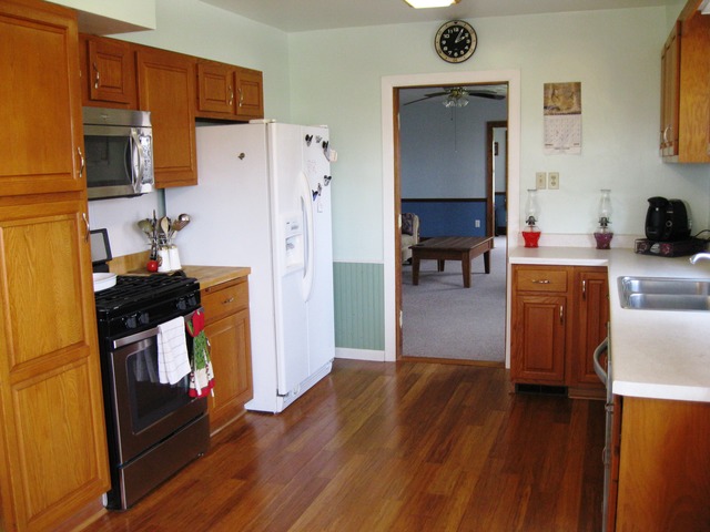 8720 Elva Road DeKalb, IL 60115 - Photo 2 of 25 a kitchen with stainless steel appliances a stove and a refrigerator