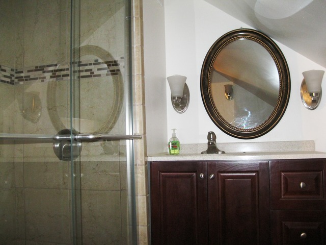 8720 Elva Road DeKalb, IL 60115 - Photo 11 of 25 a bathroom with a granite countertop sink a mirror and a shower