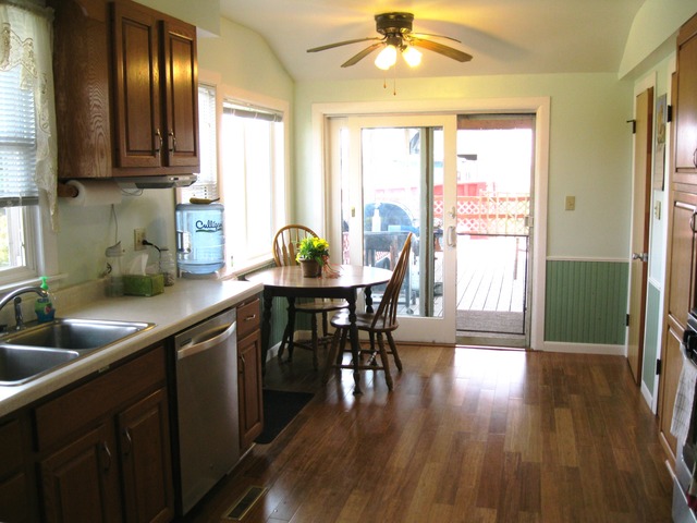 8720 Elva Road DeKalb, IL 60115 - Photo 3 of 25 a kitchen with stainless steel appliances granite countertop wooden floors a sink and a granite counter tops