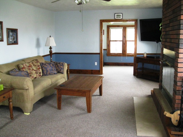 8720 Elva Road DeKalb, IL 60115 - Photo 4 of 25 a living room with furniture and a flat screen tv