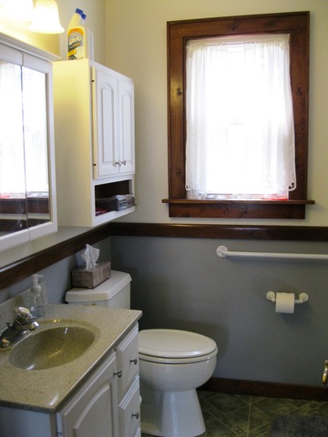 8720 Elva Road DeKalb, IL 60115 - Photo 7 of 25 a bathroom with a toilet sink and mirror