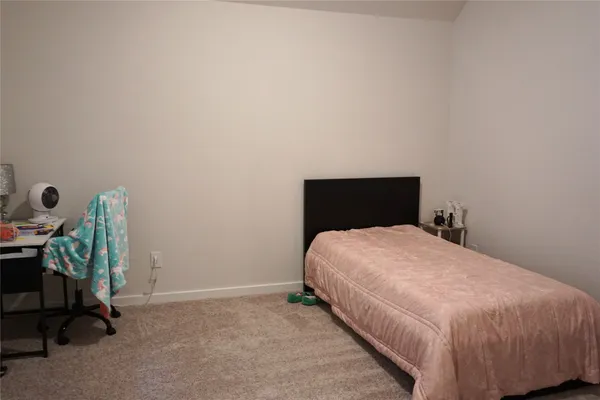 a bedroom with a bed and a chair
