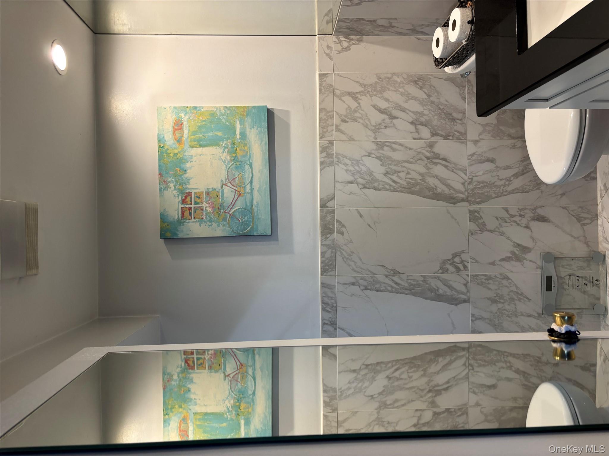 2 Richmond Road, Unit 1K Lido Beach, NY 11561 - Photo 12 of 18 a bathroom with a sink mirror and toilet