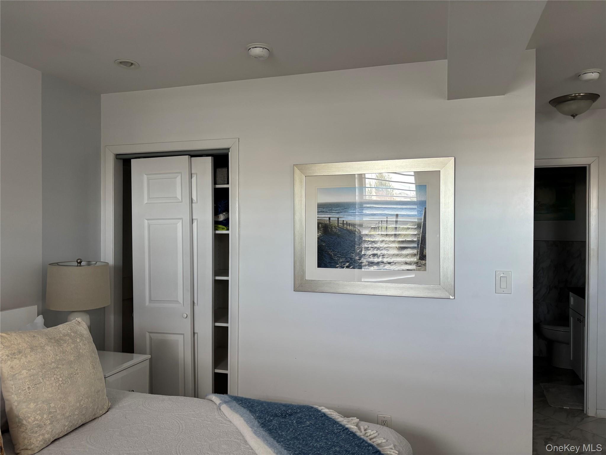 2 Richmond Road, Unit 1K Lido Beach, NY 11561 - Photo 5 of 18 a bedroom with a bed and a window